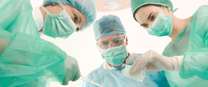 Surgeons and medical assistant wearing mask and uniform