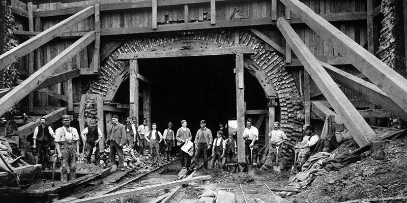 Navvies posing in front of timbering shoring up the north end of the Gill's Corner railway tunnel (Midland Counties Railway) during its reconstruction in 1892. The photo is from the National Railway Museum collection.