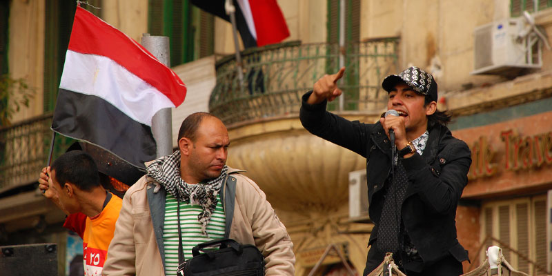 A young man speaks to a group of protesters at Tahrir Square. Cairo, Egypt.