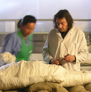 Dr Stephen Buckley applying a resin-based mixture to secure the wrappings of Alan Billis' mummified body, overseen by senior anatomical pathology technician Maxine Coe at Sheffield's Medico-Legal Centre. Photo copyright of the University of York Mummy Research Group/Dr J Fletcher