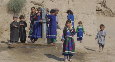 Children at a water pump in Afghanistan