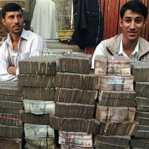 Two money-changers wait for customers at an exchange market in Kabul. (January 19, 2010 By Antoine Blua)