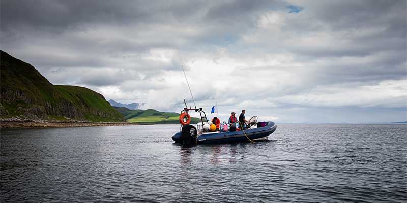 Marine biologists on a boat at sea in Scotland