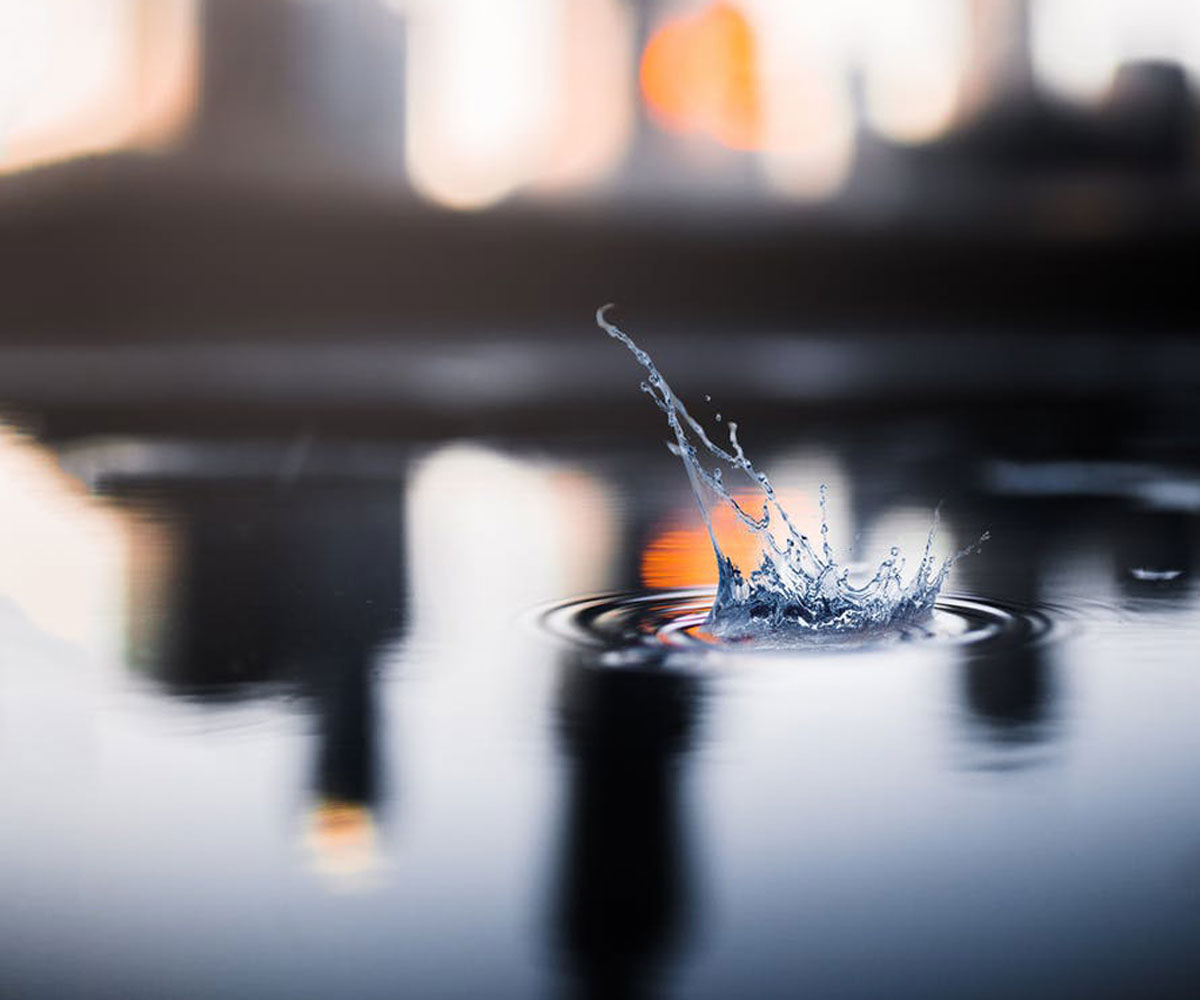 A water droplet making a splash in a body of water.