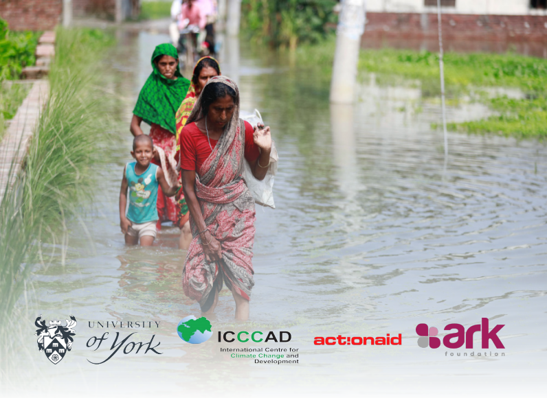 Image shows women and a child walking through flood water