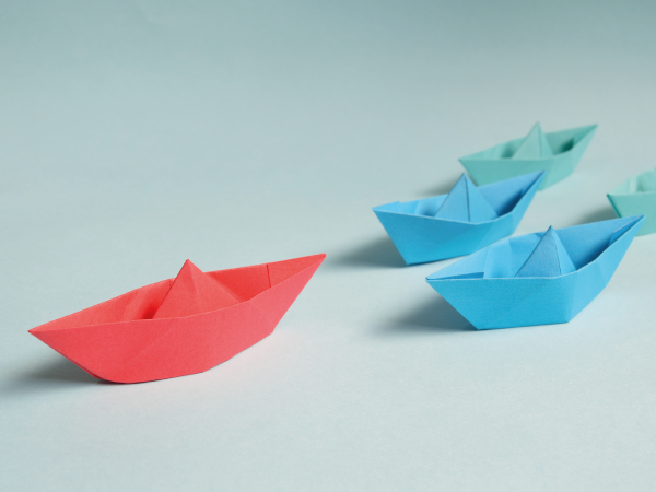 Paper boats, one leading the pack