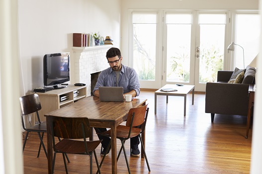 A person sitting at a home based desk