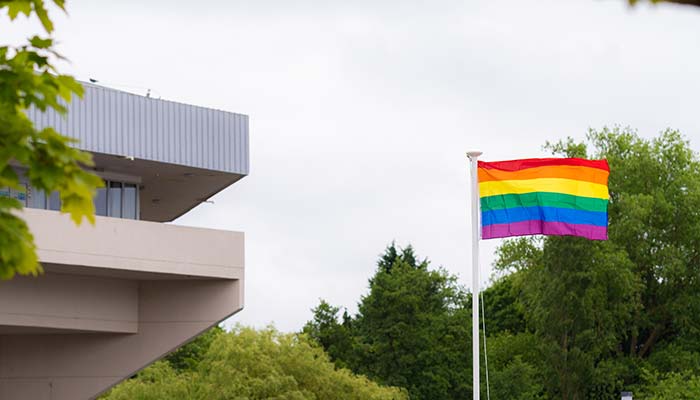 The LGBT+ Pride flag flies beside Central Hall.