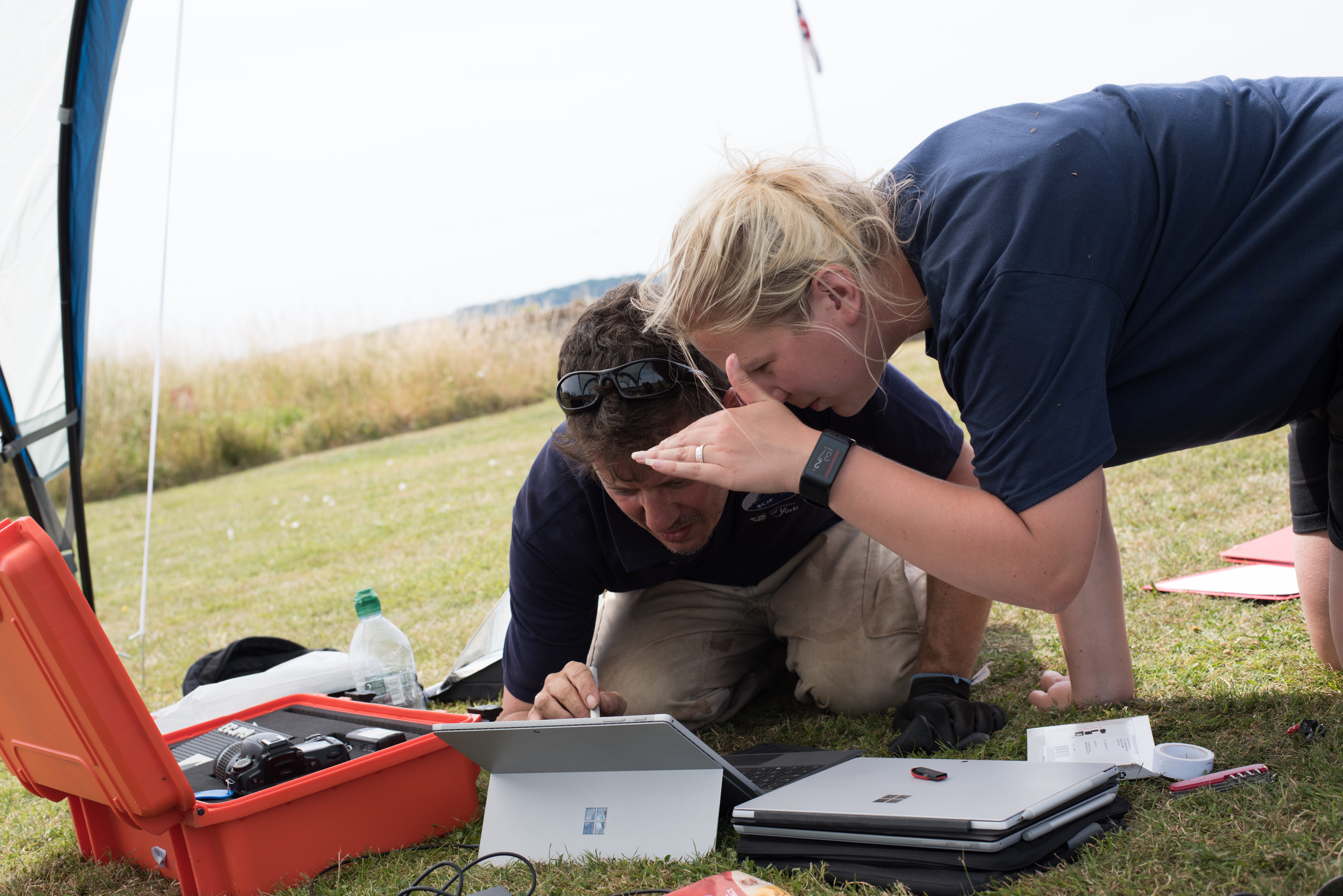 Dr James Taylor and Dr Catriona Cooper examine a tablet during the Elizabeth Castle Jersey excavation project.