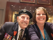 A photograph of a Normandy war veteran in uniform and a woman smiling