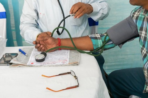 Doctor taking a man's blood pressure