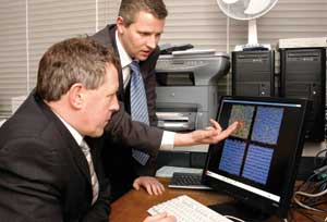 photo of Martin Bates with Rt Hon John Denham MP, explaining how computer simulation can help us understand the properties of liquid crystals.