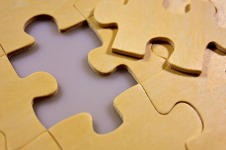 Yellow jigsaw puzzle with one piece out
