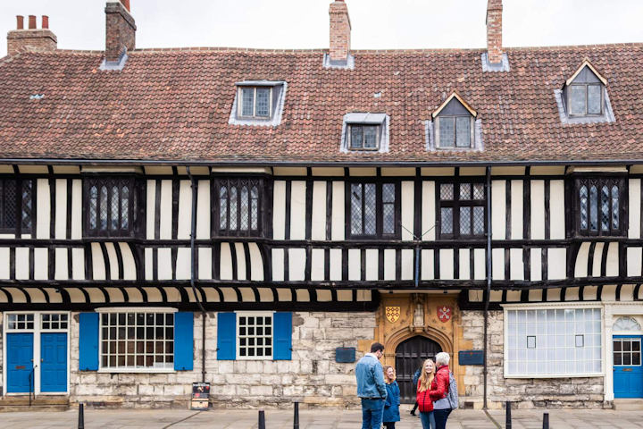People stand in front of medieval buildings in York. Image copyright University of York, Alex Holland