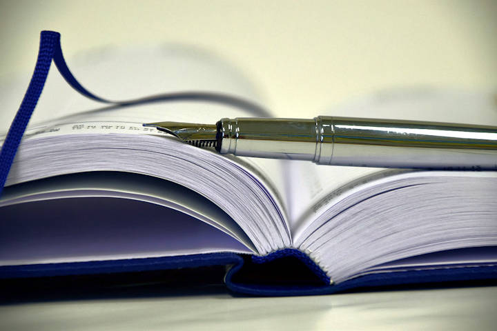 Photo of an open paper diary with a silver fountain pen