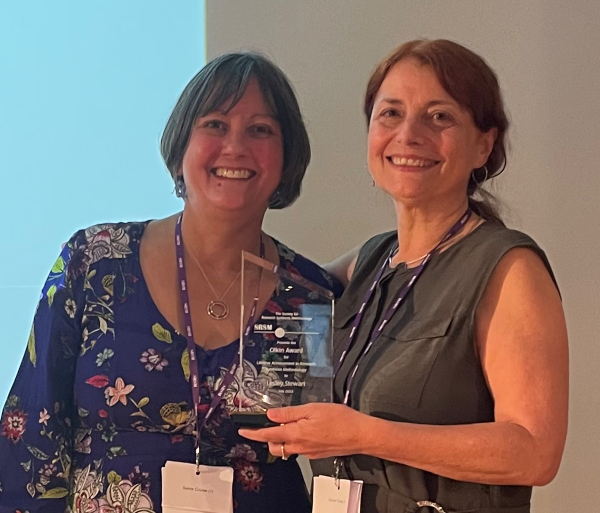 Terri Piggot presents Lesley Stewart with the Olkin Award at the 2023 SRSM meeting in Paris