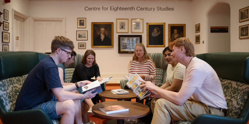 A group of students socialising in Heslington Hall.