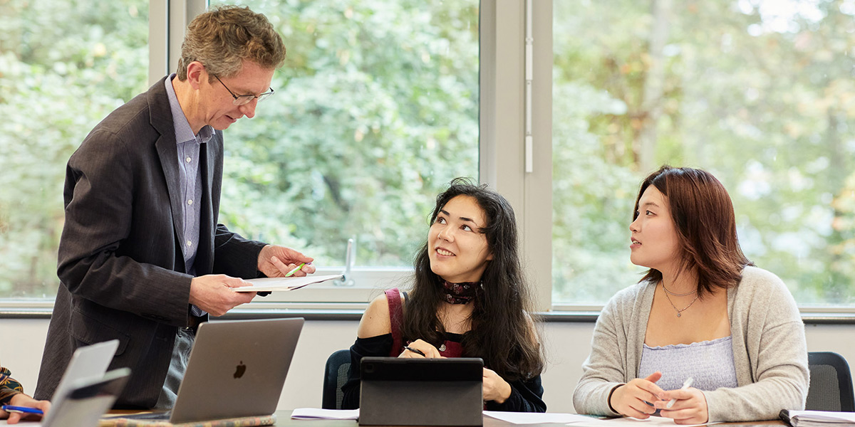 Two students and a lecturer in a seminar