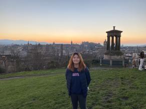 Beverly stands on top of Calton Hill, Scotland