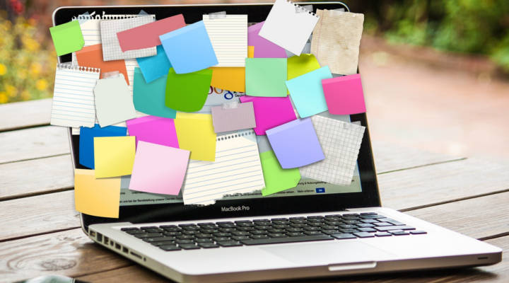 Image of a laptop with post it notes for use on Writing Resources Section of English DEpt website