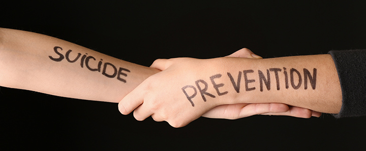 Hands joined with words suicide prevention