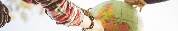 People holding globe from below