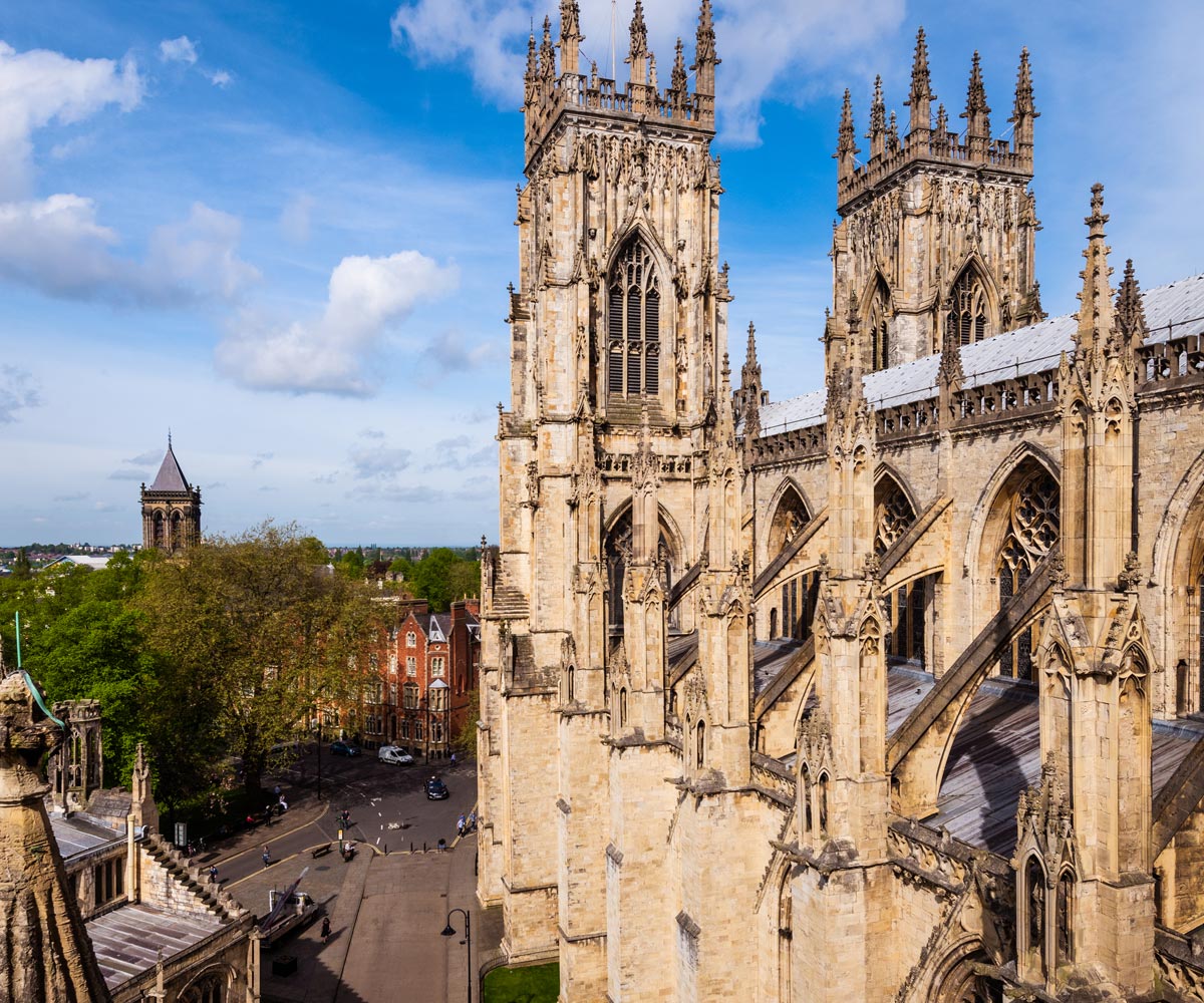 The exterior of  York minster with the city of York in the background.