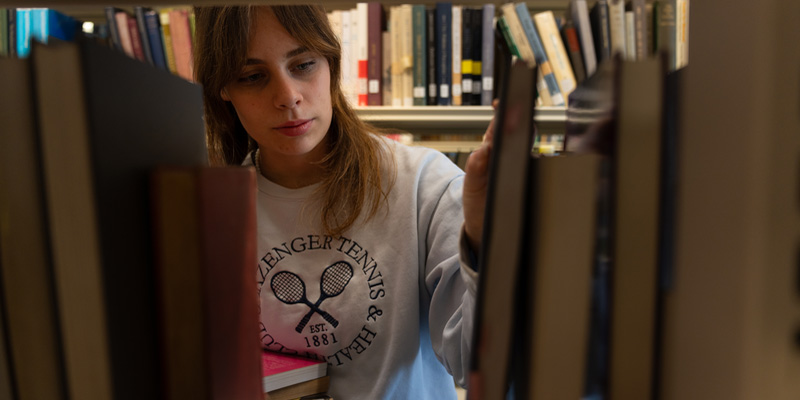 A student looking for a book in the JB Morrell Library, University of York.