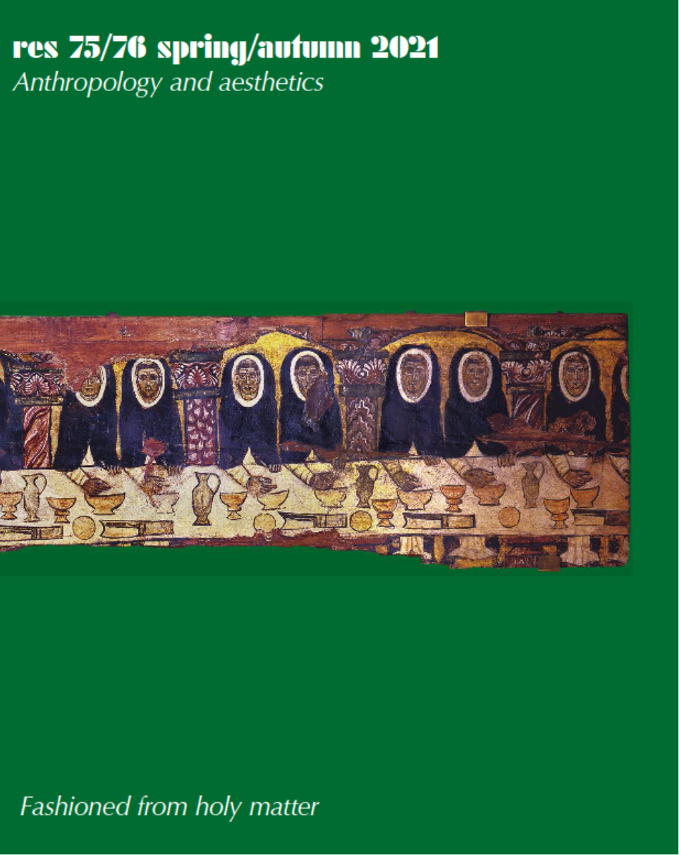 Hooded figures dining at a long table