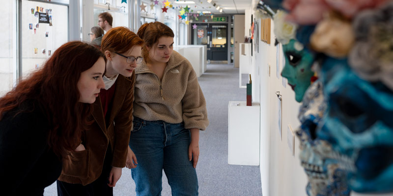 A group of students looking at an art display in the Norman Rea Gallery