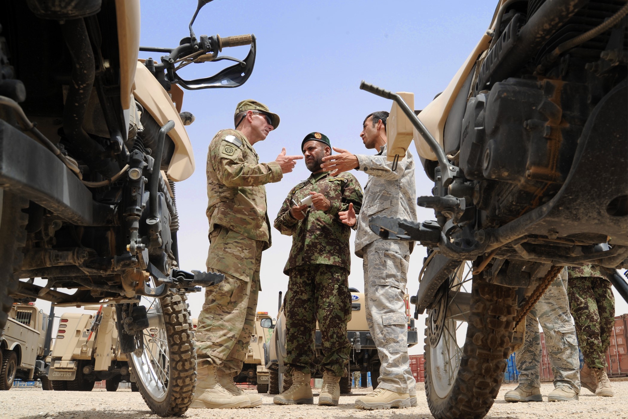 Two soldiers talking to interpreter in Afghanistan