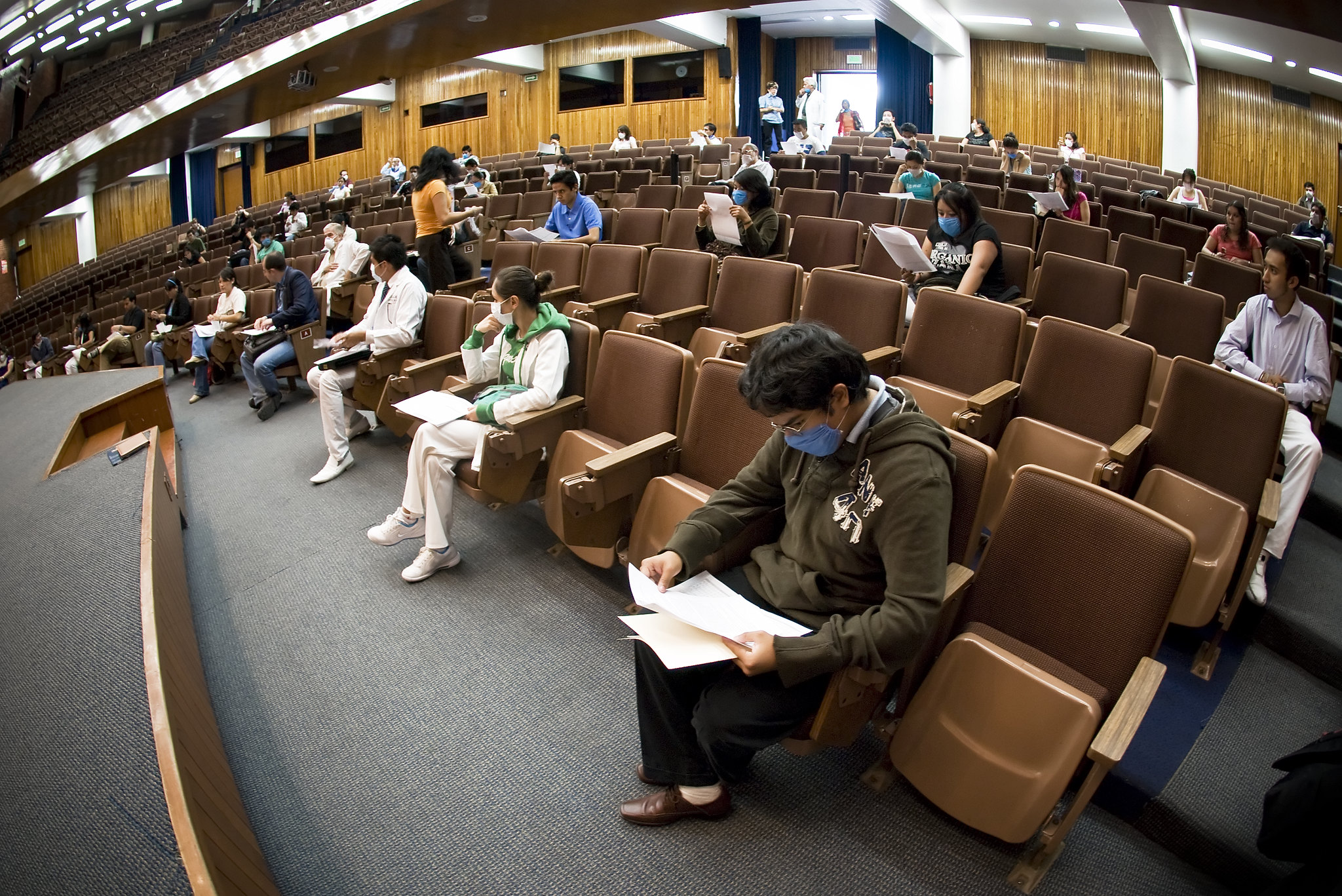 Students social distancing in a lecture theatre wearing face masks