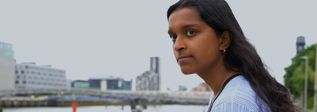 A woman looks pensively across the river Thames