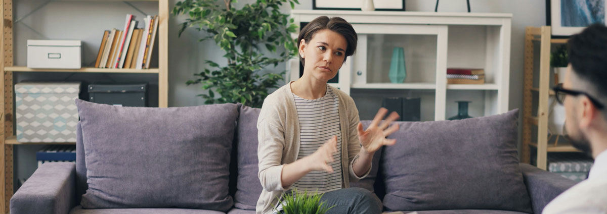 a woman talks to her financial adviser with a concerned expression