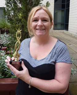 Michelle Parker holding her award