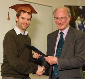 Former University Vice-Chancellor Sir Ron Cooke presents a certificate to Tom Hiskey from the Law Wizard. Photo by Keith Findlater