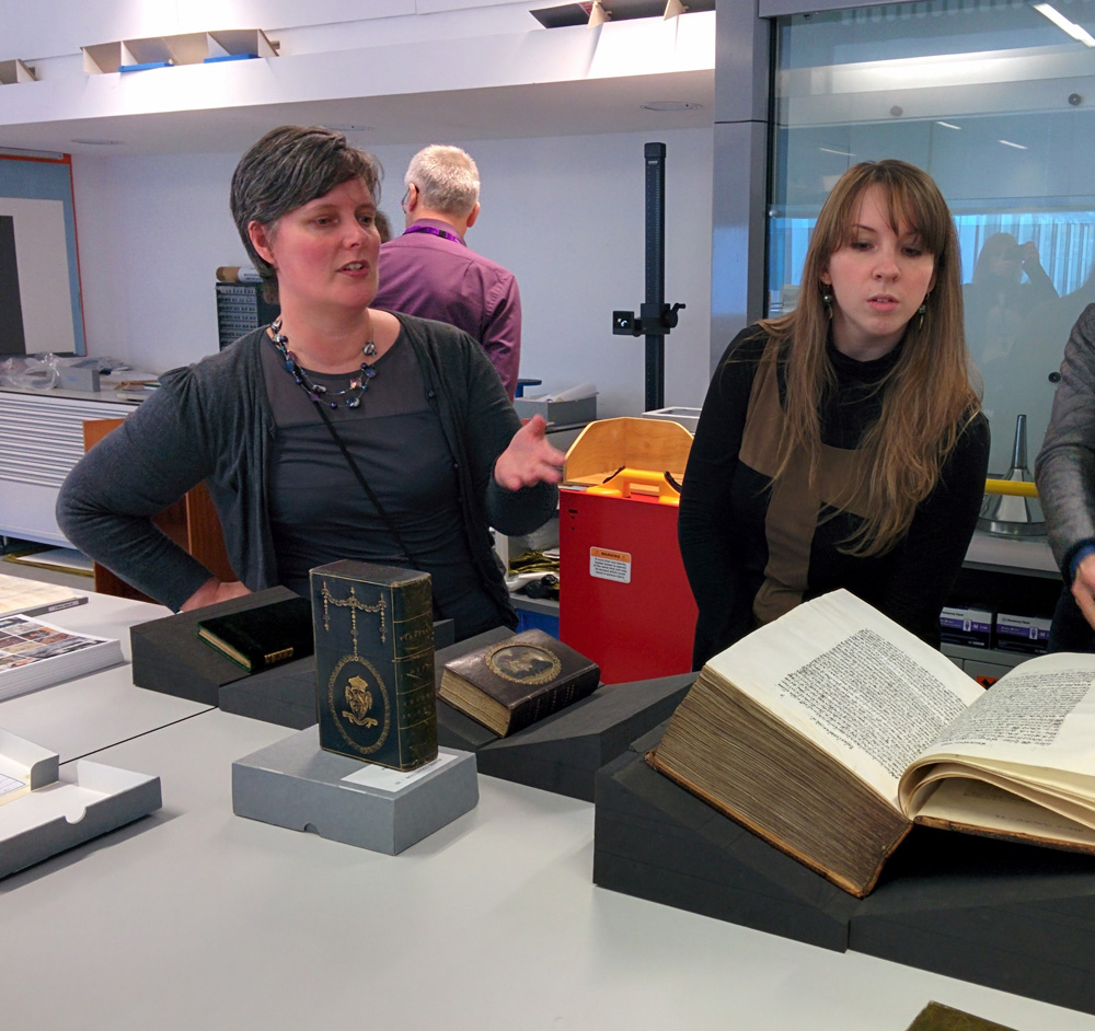 Image: Sarah Fiddyment (right) examines Codex in the Rylands Library, Manchester.