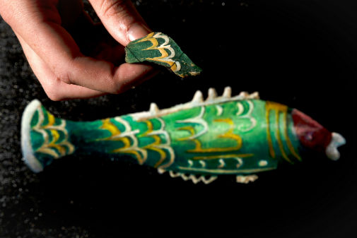 The fragment above an artist’s impression of how the fish bottle would have looked. Photograph: National Trust/Rod Kirkpatrick/F Stop Press