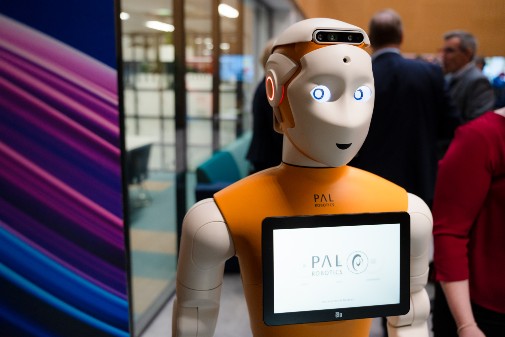 The robot instructs patients on how to use the medical equipment to measure vital signs.