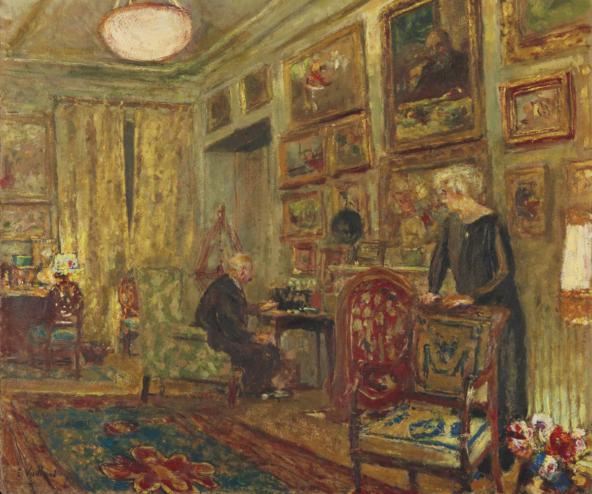 Painting by Edouard Vuillard titled Jos Hessel devant la T.S.F, rue de Naples. An older couple are in their living room with many painitngs on the walls.