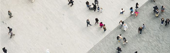 overhead photo of people walking in a concreted area