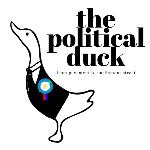 image of a duck wearing a politics society badge