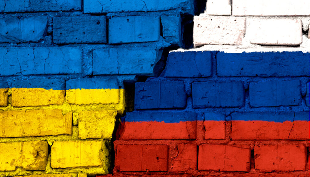 Russia-Ukraine conflict represened by a painted wall in yellow, blue, white and red