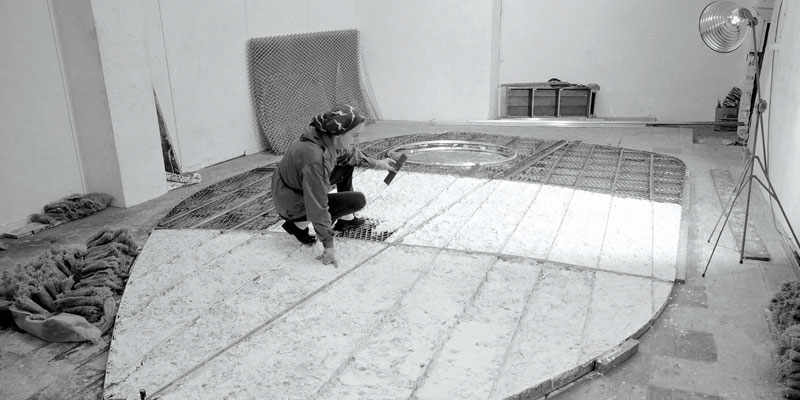 Barbara Hepworth working on the armature of Single Form in the Palais de Danse, St Ives, 1961. Photograph by Studio St Ives. Barbara Hepworth © Bowness