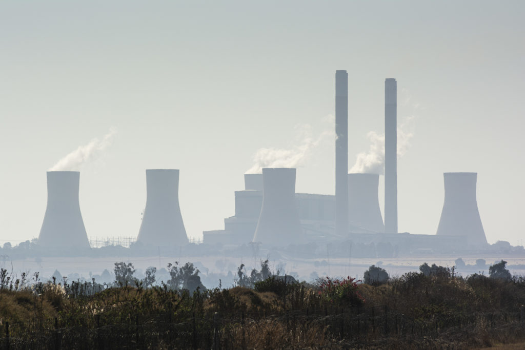 Vapour rises from cooling towers in South Africa