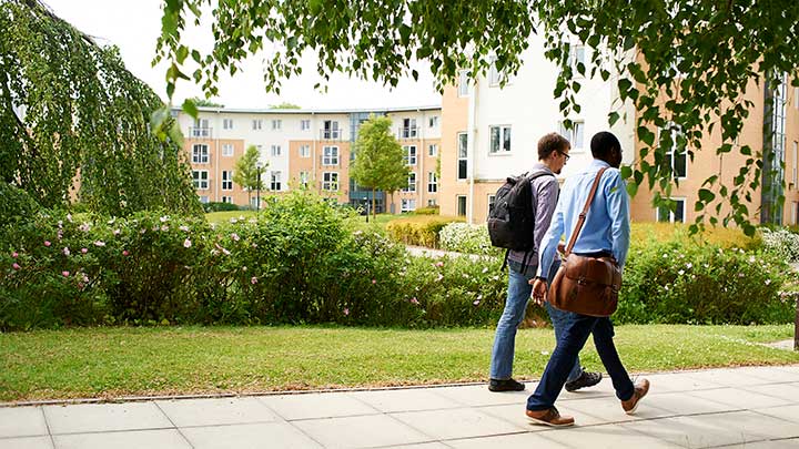 Two students walking on campus