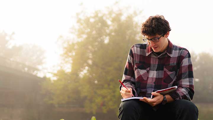 A student writing in a notebook