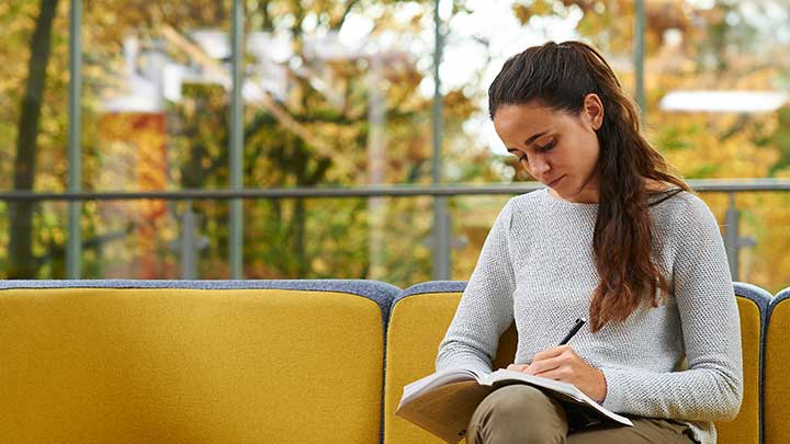 A student writing in a notebook