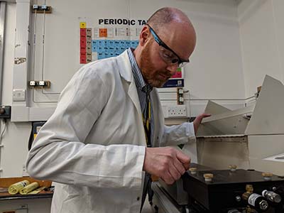 Photo of Graeme McAllister, Experimental Officer in Chemistry, working in the lab.