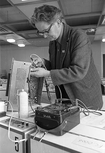 Technician handling equipment in language laboratory circa 1980